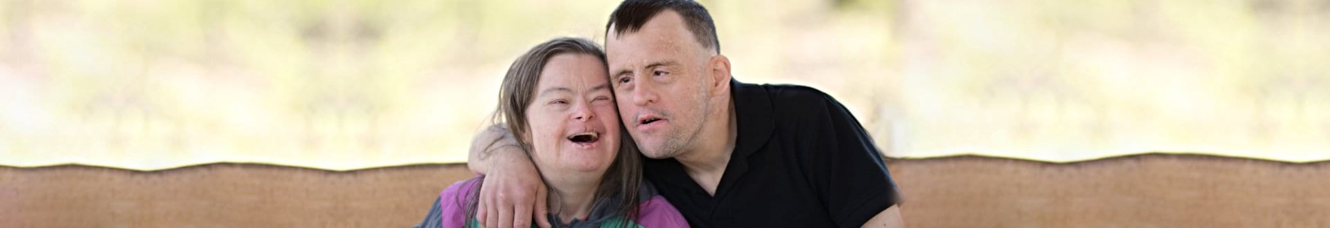 two mentally challenge people smiling