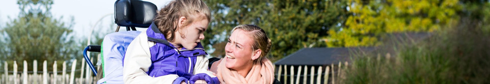 woman with mentally challenge female child smiling